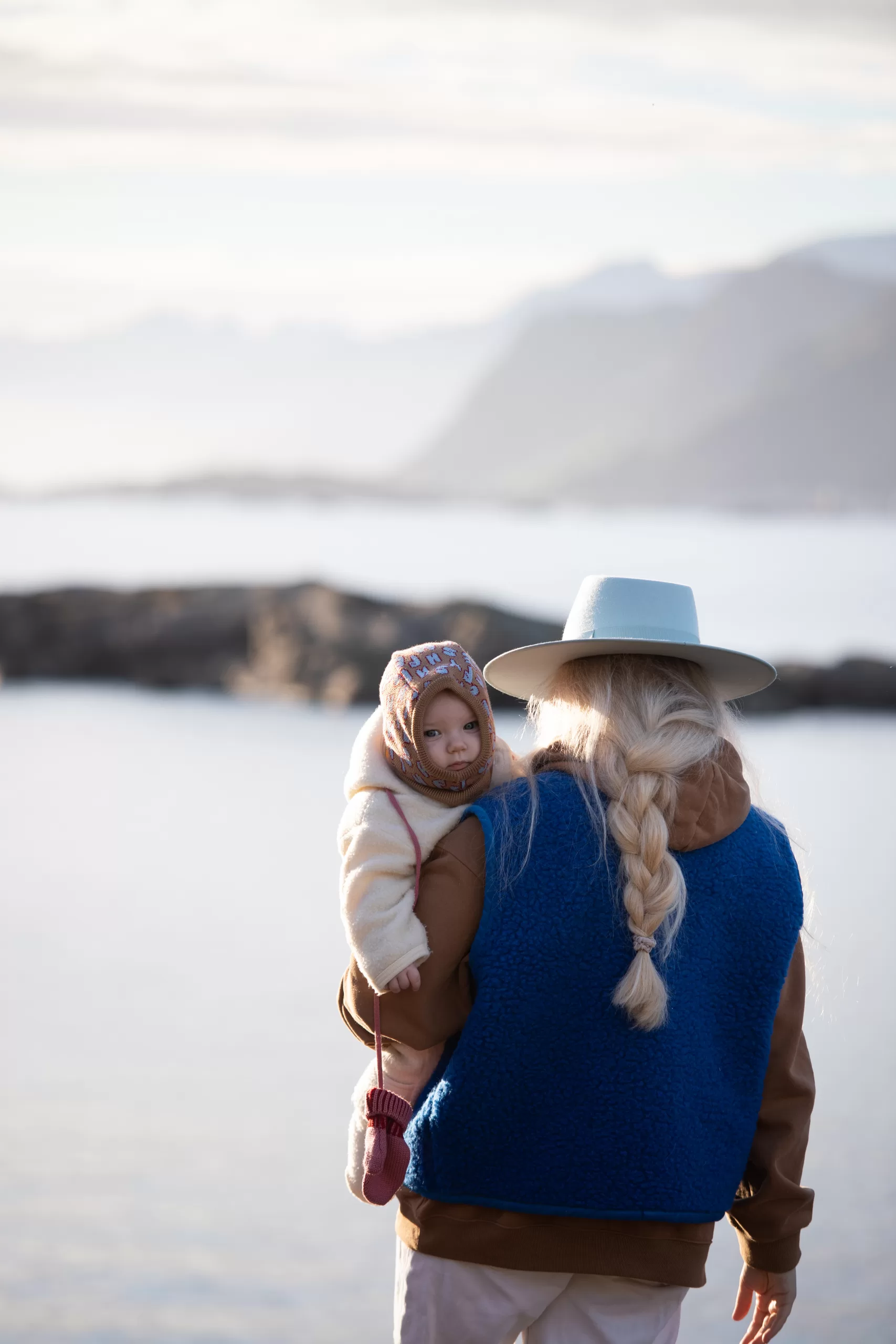 mother-holding-baby-seaside-lofoten